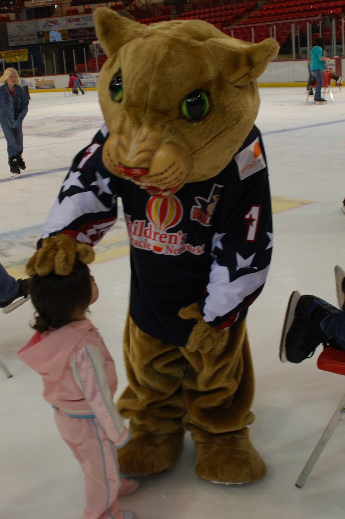 Sophia Tangarife, 2, plays with the Wichita Falls Wildcat mascot during the 3rd Annual Balfour Beatty Communities Ice-Skating Family Day at the Kay Yeagar Coliseum Feb. 27. BBC organizes events like this to give the military families an opportunity to get to know each other. (U.S. Air Force photo/Airman 1st Class Candy Miller)

