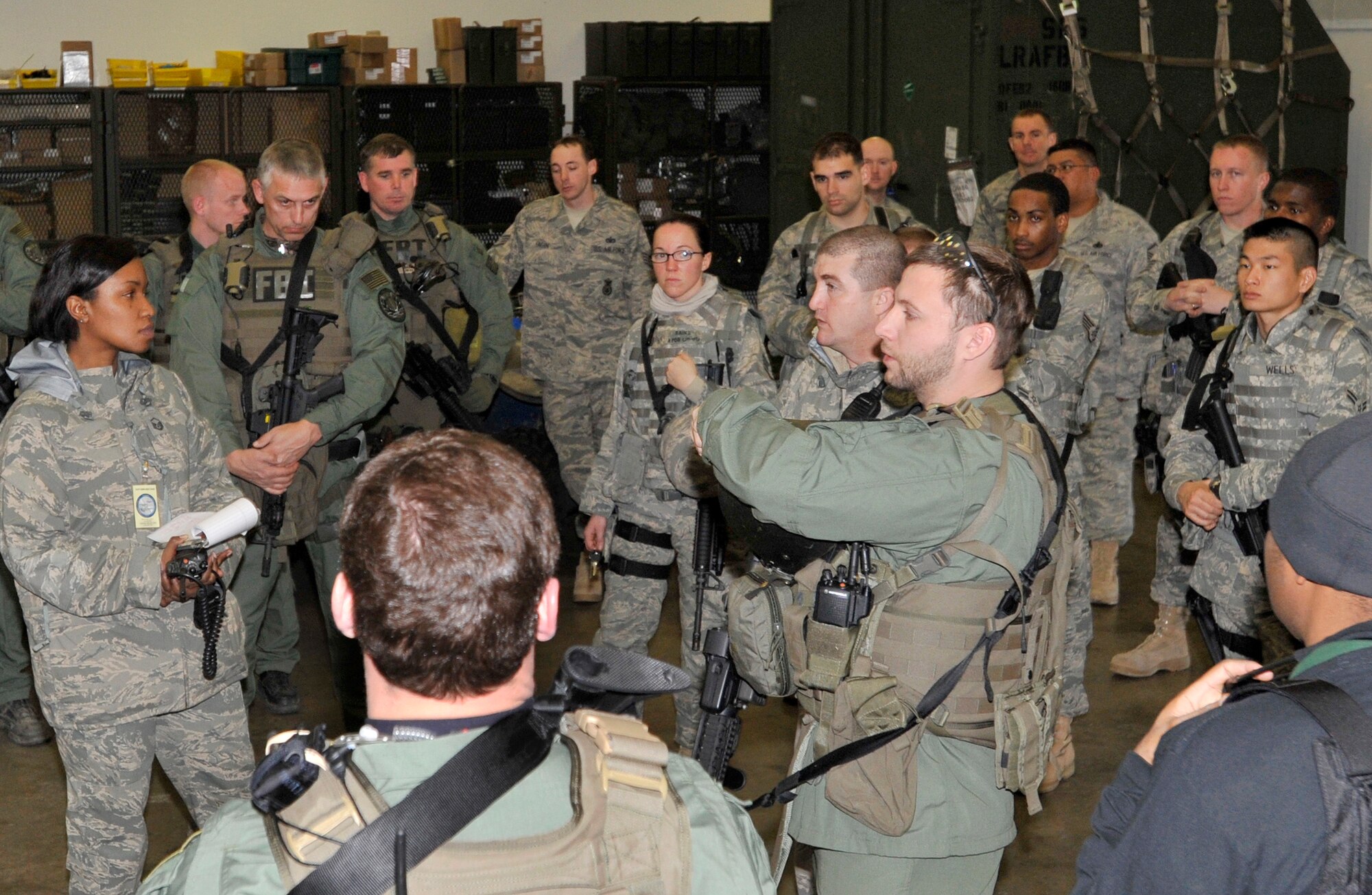 19th Security Forces Squadron Airmen, Air Force Office of Special Investigations and Federal Bureau of Investigations agents debrief Feb. 26 after joint exercise training on base. Airmen, OSI and FBI personnel took time to put real-world tactics into effect during an active shooter scenario. (U.S. Air Force photo by Christine Clark)