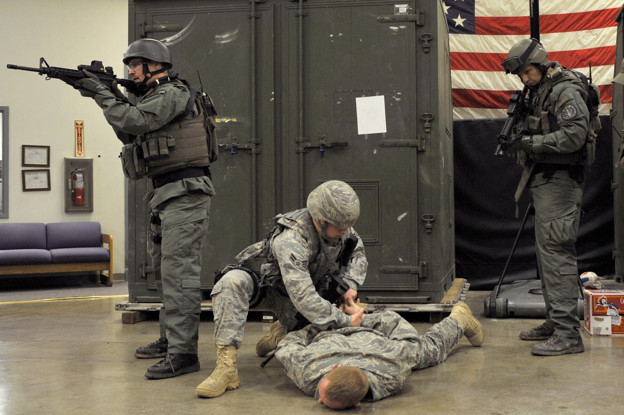 Federal Bureau of Investigations agents secure the area while Airman 1st Class Mitchell Creasy, a 19th Security Forces Squadron patrolman, detains a simulated office worker Feb. 26 during joint exercise training on base. Airmen and FBI agents practiced real-world operations during an active shooter response scenario. (U.S. Air Force photo by Christine Clark)