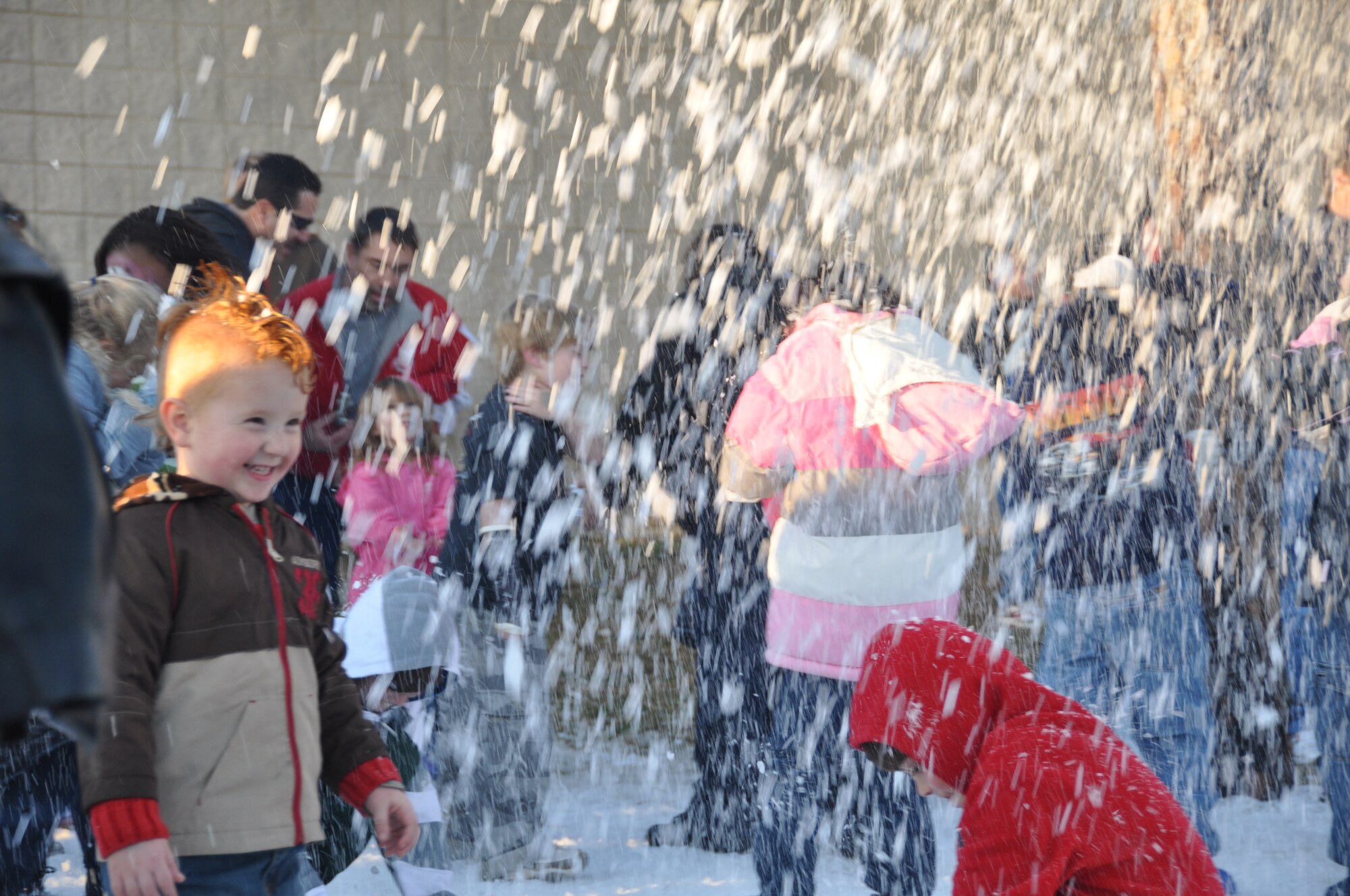 Children gather under the falling snow at Tyndall Air Force Base during the winter carnival Feb. 26.  (U.S. Air Force photo/Senior Airman Veronica McMahon)