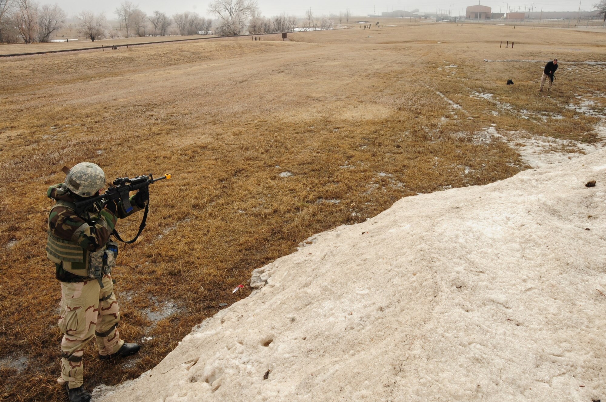 ELLSWORTH AIR FORCE BASE, S.D. -- Staff Sgt. Joseph Vawter, 28th Security Forces Squadron patrolman, fires at a simulated terrorist attempting to breach the base perimeter during a Phase II Operational Readiness Exercise, March 2.  The Phase II ORE is designed to mimic a deployed environment and test the combat abilities of Ellsworth's Airmen. (U.S. Air Force photo/Airman 1st Class Anthony Sanchelli)
