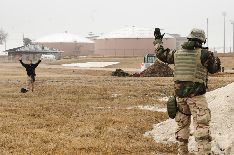 ELLSWORTH AIR FORCE BASE, S.D. -- Staff Sgt. Joseph Vawter, 28th Security Forces Squadron patrolman, halts a simulated terrorist attempting to breach the base perimeter during a Phase II Operational Readiness Exercise, March 2.  The Phase II ORE is designed to mimic a deployed environment and test the combat abilities of Ellsworth's Airmen. (U.S. Air Force photo/Airman 1st Class Anthony Sanchelli)
