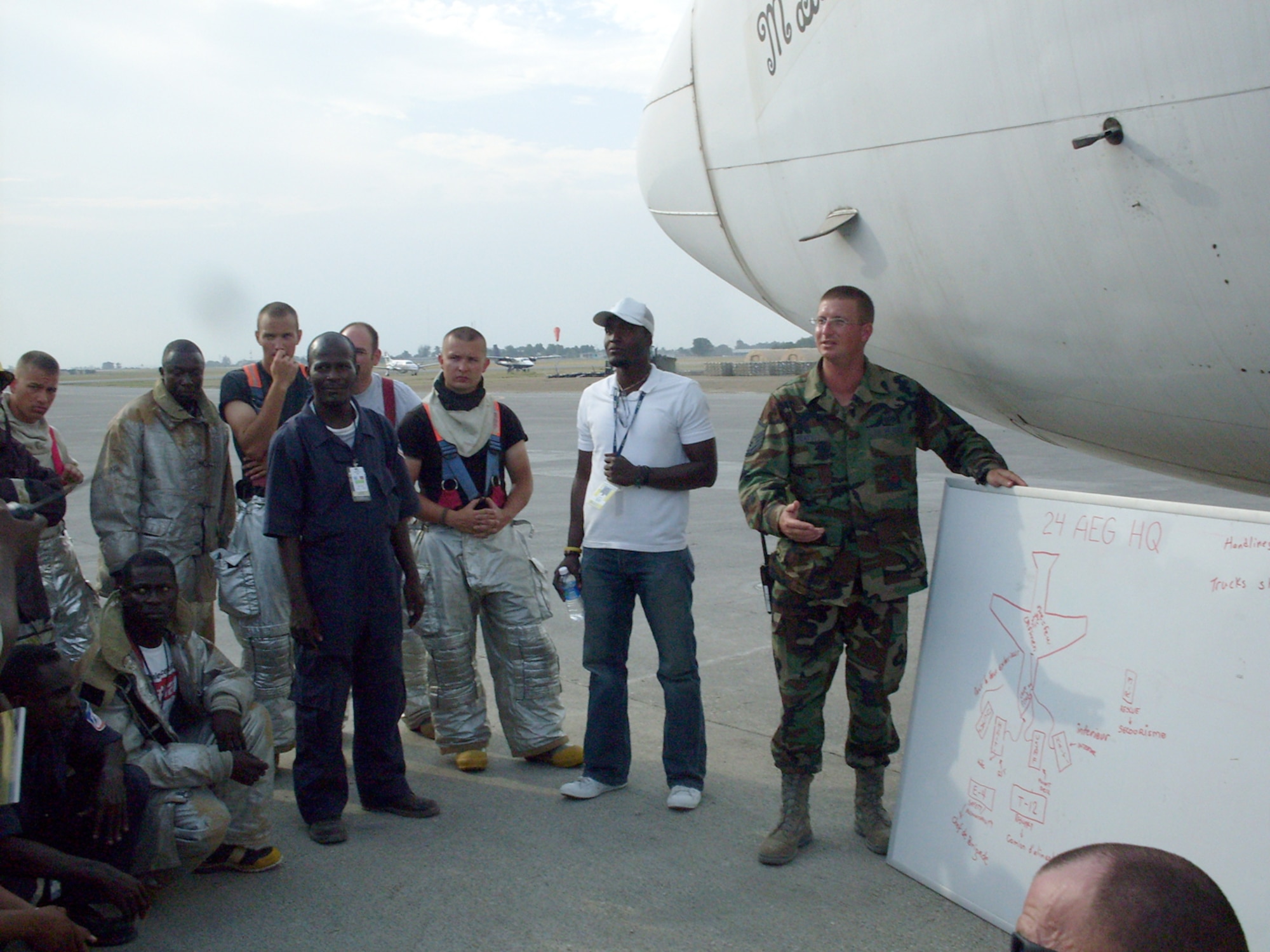 SCOTT AIR FORCE BASE, Ill. -- Master Sgt. Bradley Beaty instructs Haitian and Air Force crews on fire truck set up and entry procedures during a recent exercise at the airport in Haiti.(Courtesy Photo)