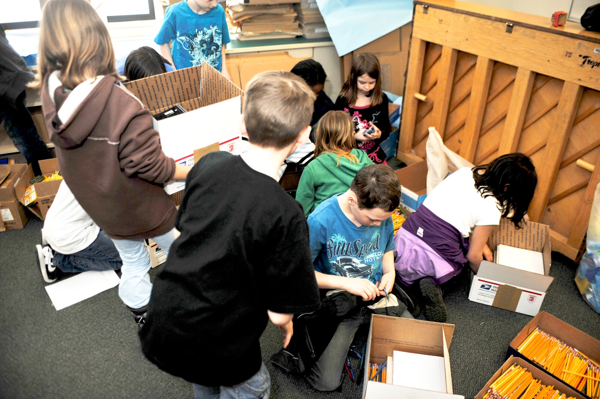 Students from Aurora Elementary School at Elmendorf Air Force Base, Alaska, work together to sort school supplies and pack them into boxes, Feb. 25, 2010, that will then be sent to students in Konar River Valley, Afghanistan. (U.S. Air Force photo/Airman 1st Class Christopher Gross) 