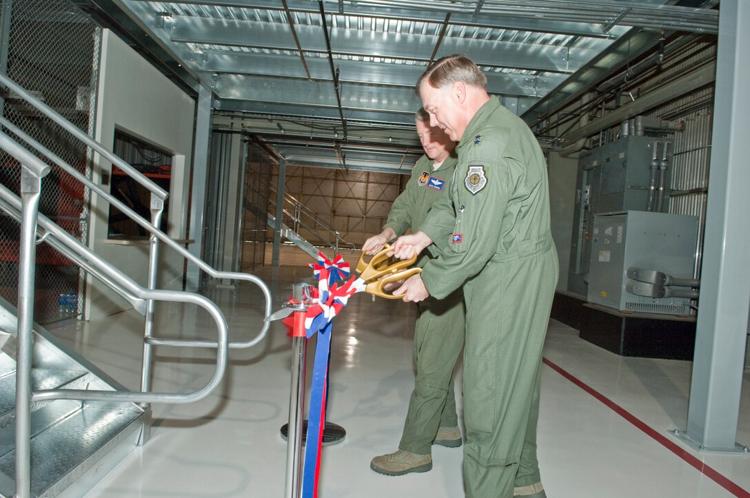 (Right) Maj. Gen. Stephen T. Sargeant, Air Force Operational Test and 
Evaluation Center Commander, and  Maj. Gen. David J. Eichhorn, Air Force 
Flight Test Center Commander, cut the ribbon and open the new mezzanine in 
Building 1810 at Edwards AFB, Calif. , on Feb. 25. The building houses the 
F-35 Joint Strike Fighter maintenance hangar and the mezzanine provides 
approximately 6,000 square feet of workspace to the JSF Operational Test Team's 
hanger for aircraft maintainers. Nearly 120 maintainers from the Air Force's 
31st Test and Evaluation Squadron, Navy, Marine Corps, and United Kingdom will 
use the work space. The project cost $690,000 and was funded by the Ministry 
of Defence United Kingdom.