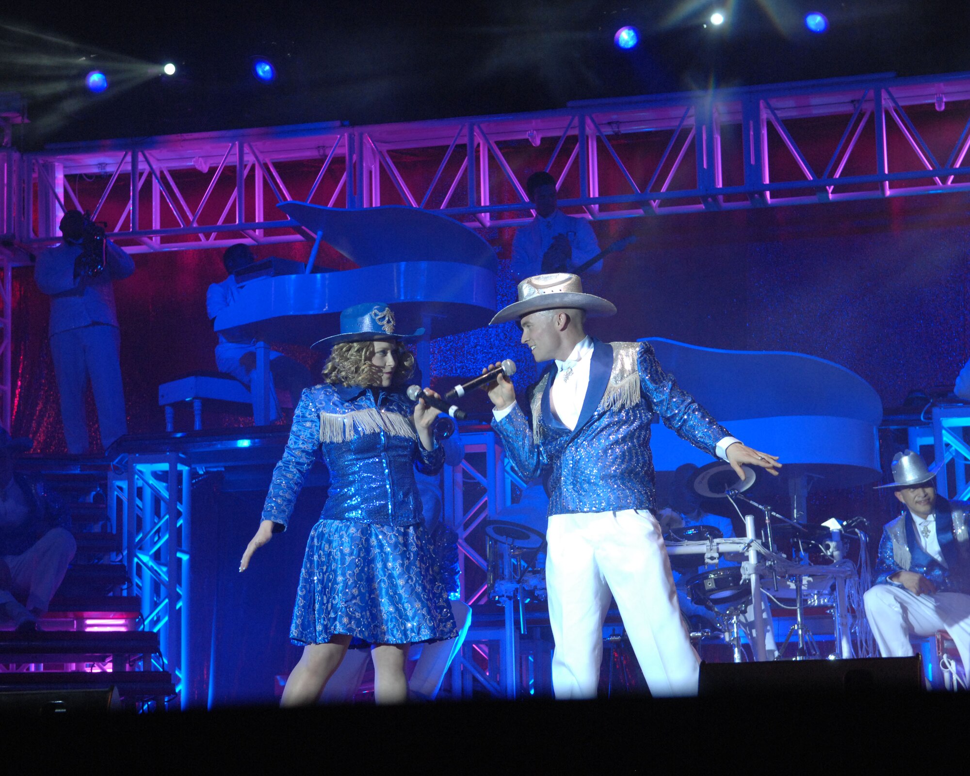 Two Tops in Blue vocalists sing a country song during a performance March 1 at the Tucson Convention Center Music Hall. The performance included music from several genres, choreographed dancing and a variety of costumes -- all in tune with this year’s tour theme “To Dream.”  Tops in Blue Airmen tour the world entertaining servicemembers and their families, while showcasing the professionalism and dedication of the United States Air Force. (U.S. Air Force photo/Staff Sgt. Alesia Goosic)