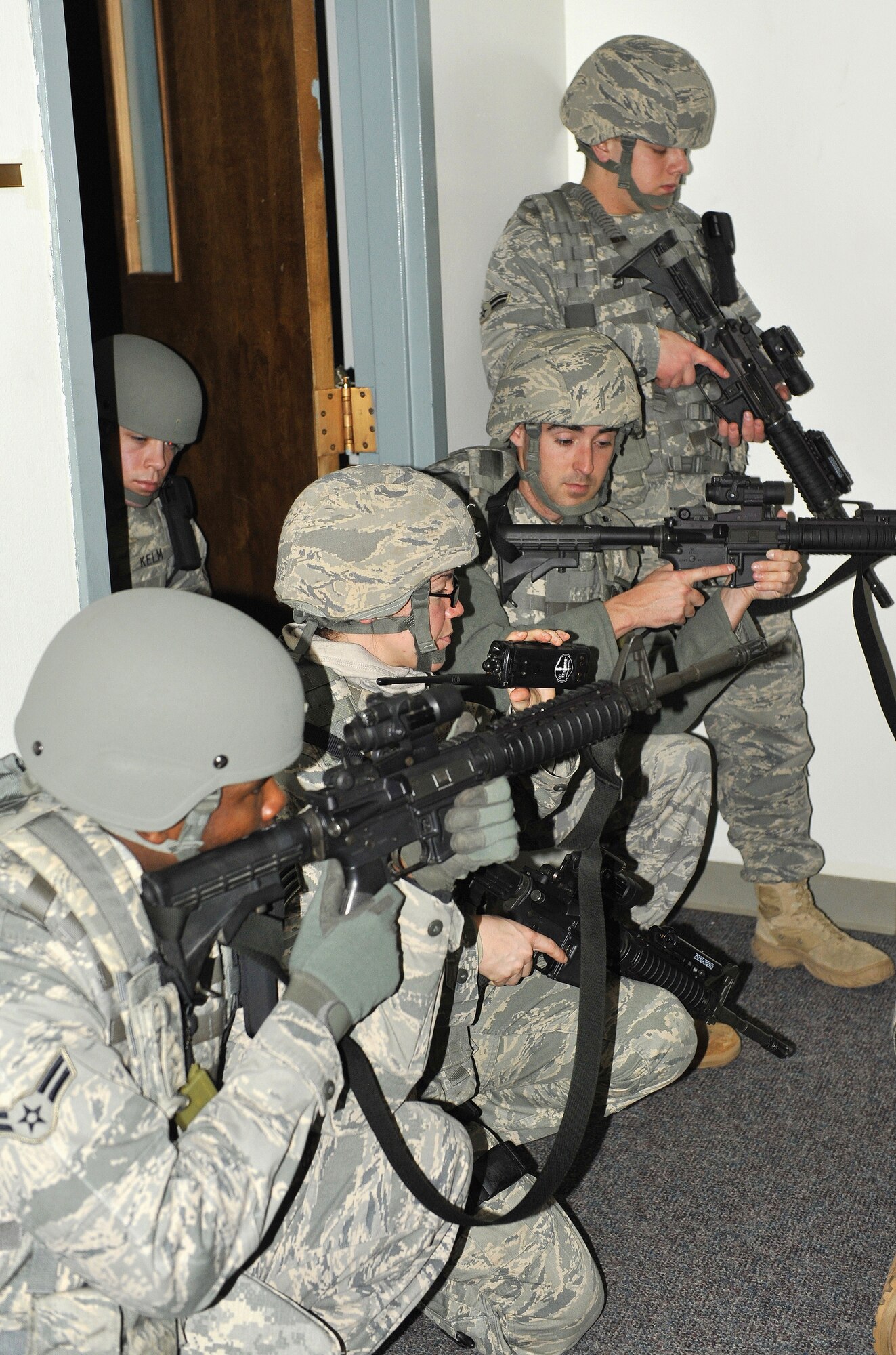 (From left to right) Airman 1st Class James Henderson, Staff Sgt. Leah Rains, Senior Airman Stephen Christian and Airman 1st Class Mitchell Creasy, 19th Security Forces Squadron patrolmen, secure and maintain their positions at Bldg. 272 Feb. 26 while notifying the Office of Special Investigations and Federal Bureau of Investigations. 19th SFS Airman, AFOSI and FBI agents train with each other and perform real world scenarios. (U.S. Air Force photo by Christine Clark)