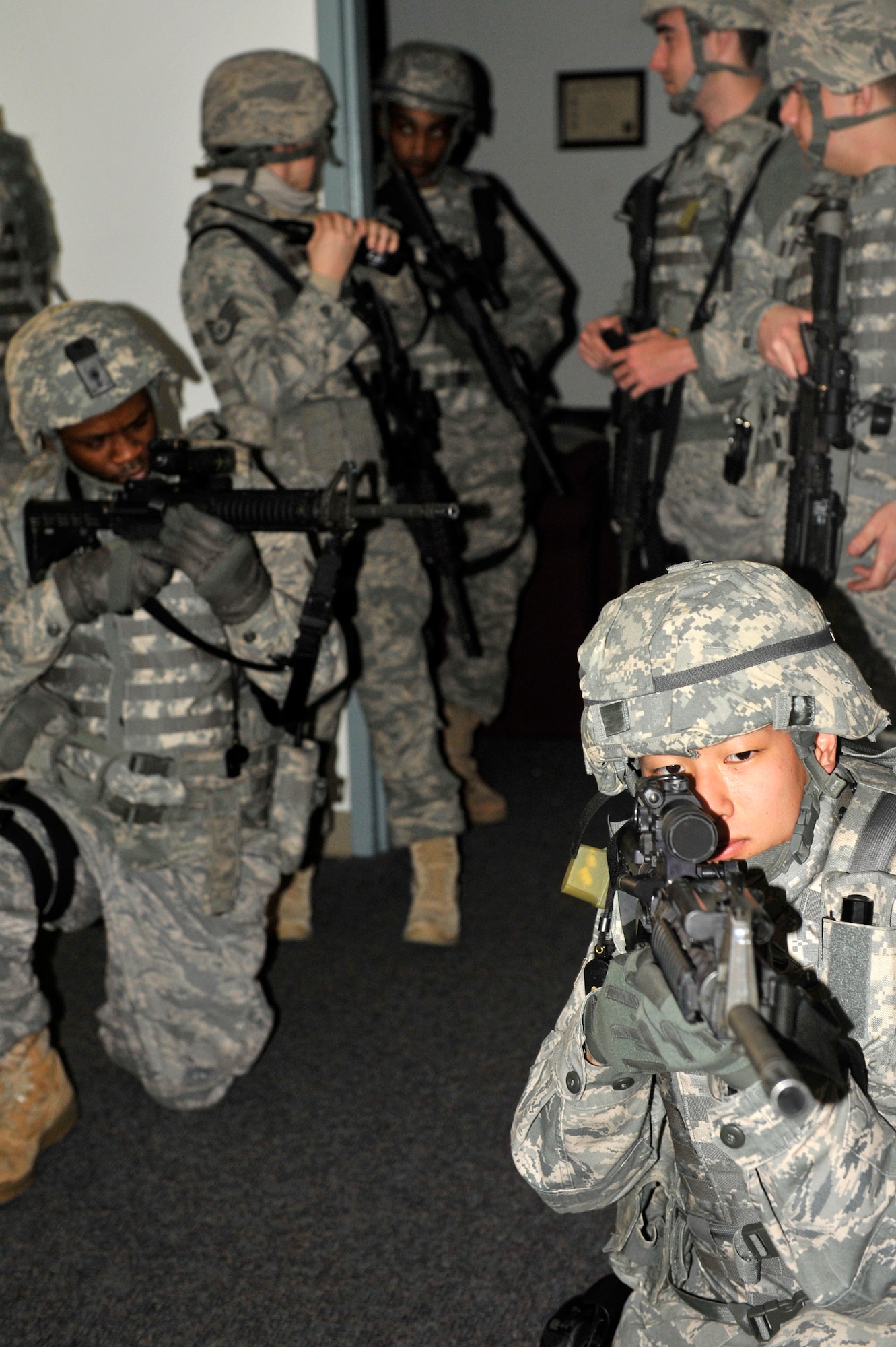 (Front) Airman 1st Class Tyler Wells and (Back) Airman 1st Class Tremain Dorsey, 19th Security Forces Squadron, secure the foothold Feb. 26 while security forces Airmen discuss how to precede into the rest of Bldg. 272. 19th SFS airman work with Air Force Office of Special Investigations and Federal Bureau of Investigations to secure one barricaded subject with an unknown number of hostages.  (U.S. Air Force photo by Christine Clark)