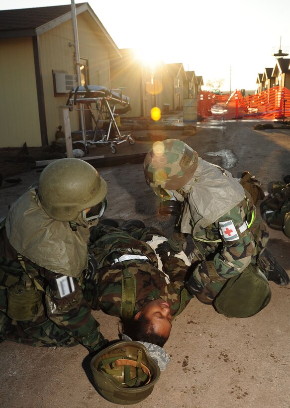 ELLSWORTH AIR FORCE BASE, S.D. -- (Left to right) Senior Airman Maya Baker and Tech. Sgt. Jacqueline McKenzie, 28th Medical Operations Squadron medical technicians, stabilize a simulated casualty during a Phase II Operational Readiness Exercise, March 2.  The Phase II ORE is designed to simulate a deployed environment and test the combat abilities of Ellsworth's Airmen. (U.S. Air Force photo/Airman 1st Class Anthony Sanchelli)
