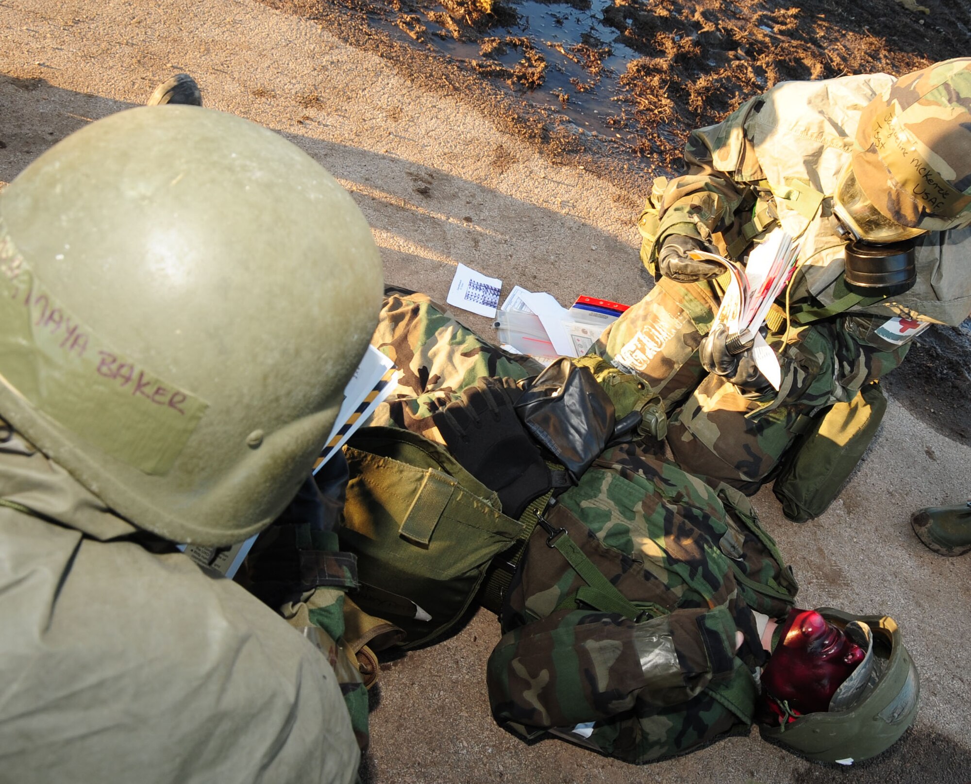ELLSWORTH AIR FORCE BASE, S.D. -- (Left to right) Senior Airman Maya Baker and Tech. Sgt. Jacqueline McKenzie, 28th Medical Operations Squadron medical technicians, find the correct procedures to stabilize a simulated burn victim who is also suffering from simulated nerve agents, in their Airmen's Manual during a Phase II Operational Readiness Exercise, March 2.  The Phase II ORE is designed to simulate a deployed environment and test the combat abilities of Ellsworth's Airmen. (U.S. Air Force photo/Airman 1st Class Anthony Sanchelli)
