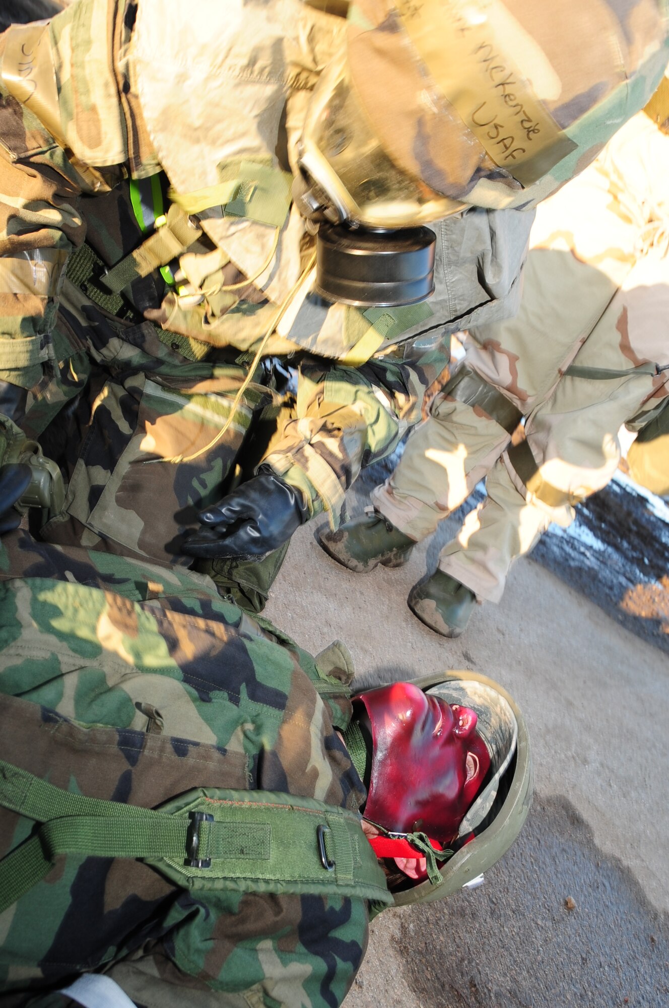 ELLSWORTH AIR FORCE BASE, S.D. -- Tech. Sgt. Jacqueline McKenzie, 28th Medical Operations Squadron medical technician, stabilizes a simulated burn victim who is also suffering from simulated nerve agents during a Phase II Operational Readiness Exercise, March 2.  The Phase II ORE is designed to simulate a deployed environment and test the combat abilities of Ellsworth's Airmen. (U.S. Air Force photo/Airman 1st Class Anthony Sanchelli)
