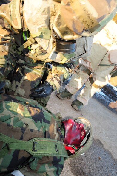 ELLSWORTH AIR FORCE BASE, S.D. -- Tech. Sgt. Jacqueline McKenzie, 28th Medical Operations Squadron medical technician, stabilizes a simulated burn victim who is also suffering from simulated nerve agents during a Phase II Operational Readiness Exercise, March 2.  The Phase II ORE is designed to simulate a deployed environment and test the combat abilities of Ellsworth's Airmen. (U.S. Air Force photo/Airman 1st Class Anthony Sanchelli)
