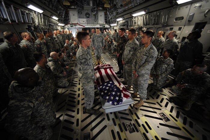 Army chaplain students observe as classmates and Joint Base Charleston Airmen perform a demonstration of a dignified transfer aboard a C-17 at JB CHS Feb. 23. The students' chaplain instructors began working with base officials in August 2008 to provide a realistic learning environment. The Army students are enrolled in the Chaplain Basic Officer Leadership Course at Fort Jackson, S.C, and the Airmen are with the JB CHS base honor guard team. (U.S. Air Force photo/Airman Samuel Goodman)