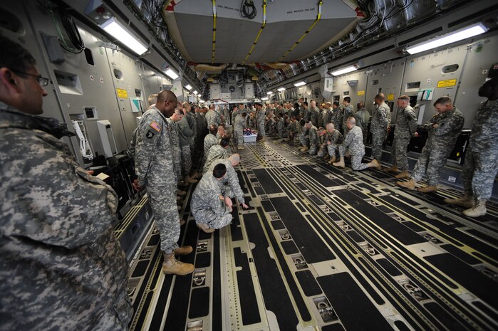 Army chaplain students and Joint Base Charleston Airmen participate in joint training on dignified transfers aboard a C-17 at JB CHS Feb. 23. To closely simulate what would be seen during a dignified transfer, a Charleston C-17 was used, along with help from JB CHS honor guard members. The Army students are enrolled in the Chaplain Basic Officer Leadership Course at Fort Jackson, S.C., and the Airmen are with the JB CHS base honor guard team. (U.S. Air Force photo/Airman Samuel Goodman)
