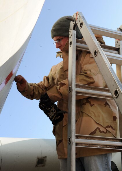 DYESS AIR FORCE BASE, Texas – Staff Sgt. Thomas Barrett, 7th Munitions Squadron, removes old paint from an airplane in the Linear Air Park, March 2. Dyess Airman volunteer to aid in the project of repainting all of the aircraft in the Linear Air Park. (U.S. Air Force photo/Airman First Class Brittney Prescott)