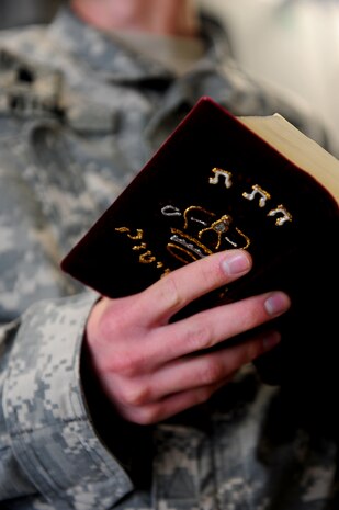An Army chaplain student enrolled in the Chaplain Basic Officer Leadership Course reads prayers during a training session on dignified transfers aboard a C-17 at Joint Base Charleston Feb. 23. The CH-BOLC is a 12-week course taught at the U.S. Army Chaplain Center and School at Fort Jackson, S.C. (U.S. Air Force photo/Staff Sgt. Ali Flisek)