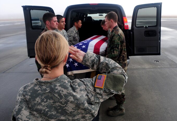 Army 2nd Lt. Michelle Carson renders a salute as Joint Base Charleston honor guard members prepare to carry an empty casket onto a C-17 during a dignified transfer training session at Joint Base Charleston Feb. 23. The training was part of a 12-week course taught at the U.S. Army Chaplain Center and School at Fort Jackson, S.C. Lieutenant Carson is a student enrolled in the Chaplain Basic Officer Leadership Course at the USACHCS. (U.S. Air Force photo/Staff Sgt. Ali Flisek)