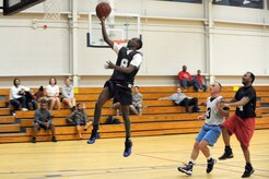 Anthony Burdette goes for a lay up as Antonio Hill, right, and Bob Bryant, center, wait for a rebound during the intramural basketball game held at the Fitness and Sports Center March 2, 2010, at Joint Base Charleston, S.C. The 628th Logistics Readiness Squadron defeated the 437th Operations Support Squadron 45-37, which brought their winning streak to 4-0 for the season so far. Burdette and Hill are both assigned to the 628 LRS and Bryant is assigned to the 437 OSS. (U.S. Air Force photo/Staff Sgt. Marie Brown)