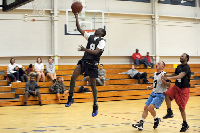 Anthony Burdette goes for a lay up as Antonio Hill, right, and Bob Bryant, center, wait for a rebound during the intramural basketball game held at the Fitness and Sports Center March 2, 2010, at Joint Base Charleston, S.C. The 628th Logistics Readiness Squadron defeated the 437th Operations Support Squadron 45-37, which brought their winning streak to 4-0 for the season so far. Burdette and Hill are both assigned to the 628 LRS and Bryant is assigned to the 437 OSS. (U.S. Air Force photo/Staff Sgt. Marie Brown)