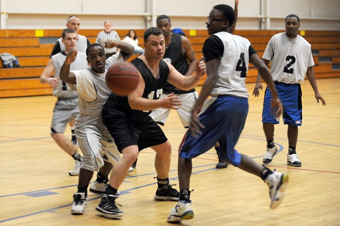 Robert Degregorio, center, along with 437th Operations Support Squadron competitors try to catch the ball before it lands out of bounds during the intramural basketball game held at the Fitness and Sports Center March 2, 2010, at Joint Base Charleston, S.C. The 628th Logistics Readiness Squadron defeated the 437 OSS 45-37, which brought their winning streak to 4-0 for the season so far. Degregorio is assigned to the 628 LRS. (U.S. Air Force photo/Staff Sgt. Marie Brown)