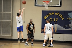 Joshua Hall tries for a jump shot as a teammate and 628th Logistics Readiness Squadron competitors wait for the rebound during the intramural basketball game held at the Fitness and Sports Center March 2, 2010, at Joint Base Charleston, S.C. The 628th Logistics Readiness Squadron defeated the 437th Operations Support Squadron 45-37, which brought their winning streak to 4-0 for the season so far. Hall is assigned to the 437 OSS. (U.S. Air Force photo/Staff Sgt. Marie Brown)