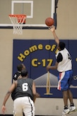 Lun Fox, front left, and Fernando Whitten, back left, wait for the rebound after Daniel Clarke tries for a lay up during the intramural basketball game held at the Fitness and Sports Center March 2, 2010, at Joint Base Charleston, S.C. The 628th Logistics Readiness Squadron's record is at 4-0 and the 437th Operations Support Squadron is at 1-4 so far this season. Fox and Whitten are both assigned to the 628 LRS and Clarke is assigned to the 437 OSS. (U.S. Air Force photo/Staff Sgt. Marie Brown)