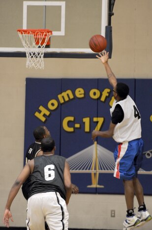 Lun Fox, front left, and Fernando Whitten, back left, wait for the rebound after Daniel Clarke tries for a lay up during the intramural basketball game held at the Fitness and Sports Center March 2, 2010, at Joint Base Charleston, S.C. The 628th Logistics Readiness Squadron's record is at 4-0 and the 437th Operations Support Squadron is at 1-4 so far this season. Fox and Whitten are both assigned to the 628 LRS and Clarke is assigned to the 437 OSS. (U.S. Air Force photo/Staff Sgt. Marie Brown)