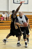 Lun Fox tries to block a shot by Humberto Camara during the intramural basketball game held at the Fitness and Sports Center March 2, 2010, at Joint Base Charleston, S.C. There are currently 16 teams competing for the base championship during this season, which will come to an end in early April. Fox is assigned to the 628th Logistics Readiness Squadron and Camara is assigned to the 437th Operations Support Squadron. (U.S. Air Force photo/Staff Sgt. Marie Brown)