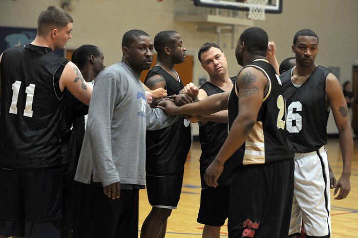 Members of the 628th Logistics Readiness Squadron huddle for a team cheer prior to the start of the intramural basketball game held at the Fitness and Sports Center March 2, 2010, at Joint Base Charleston, S.C. The 628 LRS outlasted the 437th Operations Support Squadron 45-37. (U.S. Air Force photo/Staff Sgt. Marie Brown)