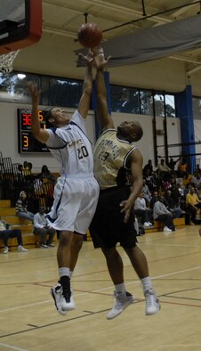 Staff Sgt. Larry Bledsoe, 1st Special Operations Aircraft Maintenance Squadron, right, reaches for the rebound under Trevon Nicholson, Keesler Dragons, during the 2010 Southeastern Military Athletic Conference tournament at the Hurlburt Field Aderholt Fitness Center Feb. 28. The Air Commandos defeated the Dragons in the championship game 82-52. (U.S. Air Force photo by Airman 1st Class Joe McFadden)