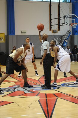Airman 1st Class Jammar Major, 1st Special Operations Aircraft Maintenance Squadron, left, prepares to jump for the ball against Lester Marshall, Keesler Dragons, during the 2010 Southeastern Military Athletic Conference tournament at the Hurlburt Field Aderholt Fitness Center Feb. 27. The Air Commandos defeated the Dragons in the championship game 82-52. (U.S. Air Force photo by Airman Caitlin O'Neil-McKeown)