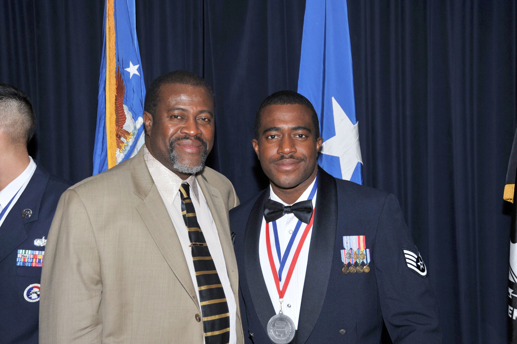 OFFUTT AIR FORCE BASE, Neb. - Staff Sgt. Bernard Byer Jr., with the 390th Intelligence Squadron, poses for a photograph with his father, Bernard Byer Sr., Feb. 26 during the 55th Wing Annual Awards Banquet at the Patriot Club here. Sergeant Byer won the Non-commissioned Officer of the Year Award. U.S. Air Force photo by D.P. Heard