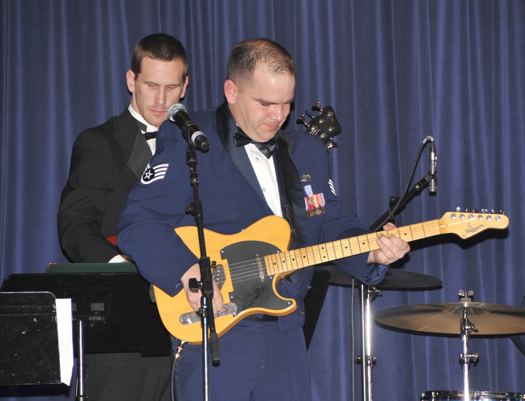 OFFUTT AIR FORCE BASE, Neb. - Staff Sgt. Ryan Manzi, a guitarist with the Heartland of America Band's ensemble "Raptor," plays a guitar solo during the group's performance Feb. 26 at the 55th Wing Annual Awards Banquet at the Patriot Club here. U.S. Air Force photo by D.P. Heard