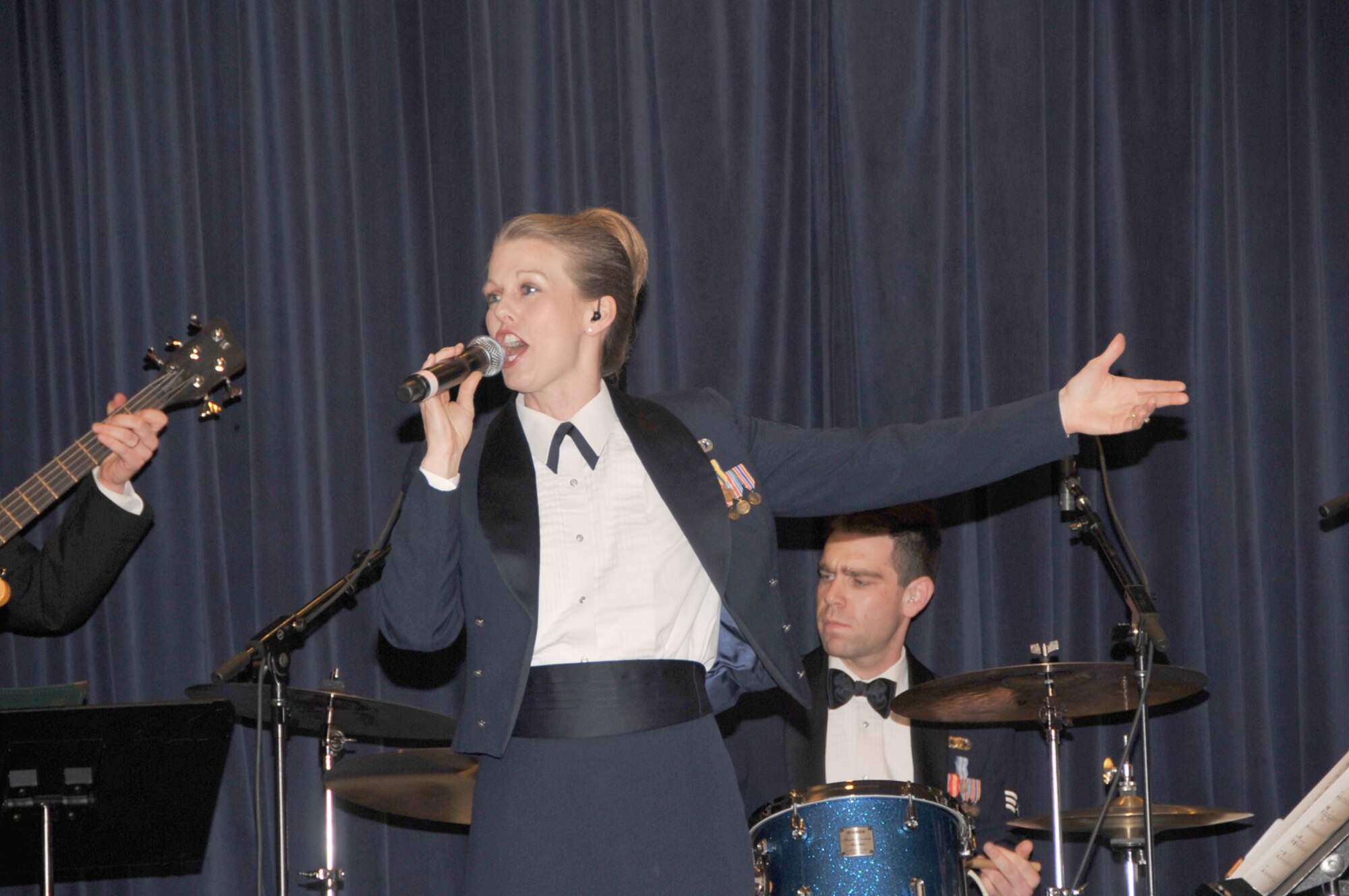 OFFUTT AIR FORCE BASE, Neb. - Staff Sgt. Krista Joyce, a singer with the Heartland of America Band's ensemble "Raptor," performs with the group at the Patriot Club here Feb. 26 during the 55th Wing Annual Awards Banquet. U.S. Air Force photo by D.P. Heard