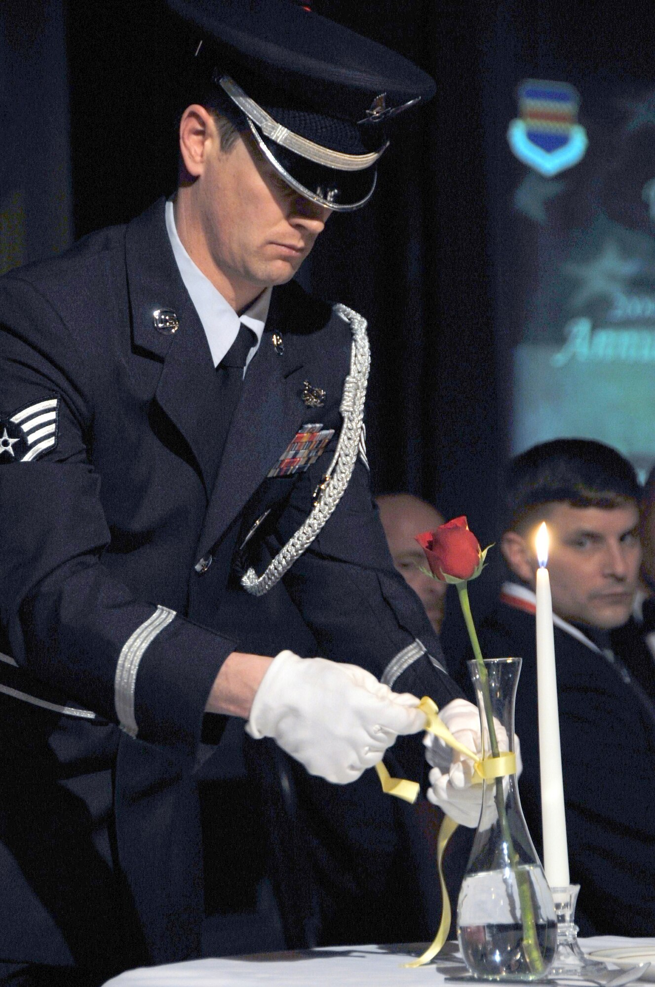 OFFUTT AIR FORCE BASE, Neb. - A member of the Offutt Honor Guard ties a yellow ribbon around a vase during the POW/MIA ceremony at the 55th Wing Annual Awards Banquet Feb. 26 at the Patriot Club here. The ceremony honored all servicemembers who never made it home. U.S. Air Force photo by D.P. Heard