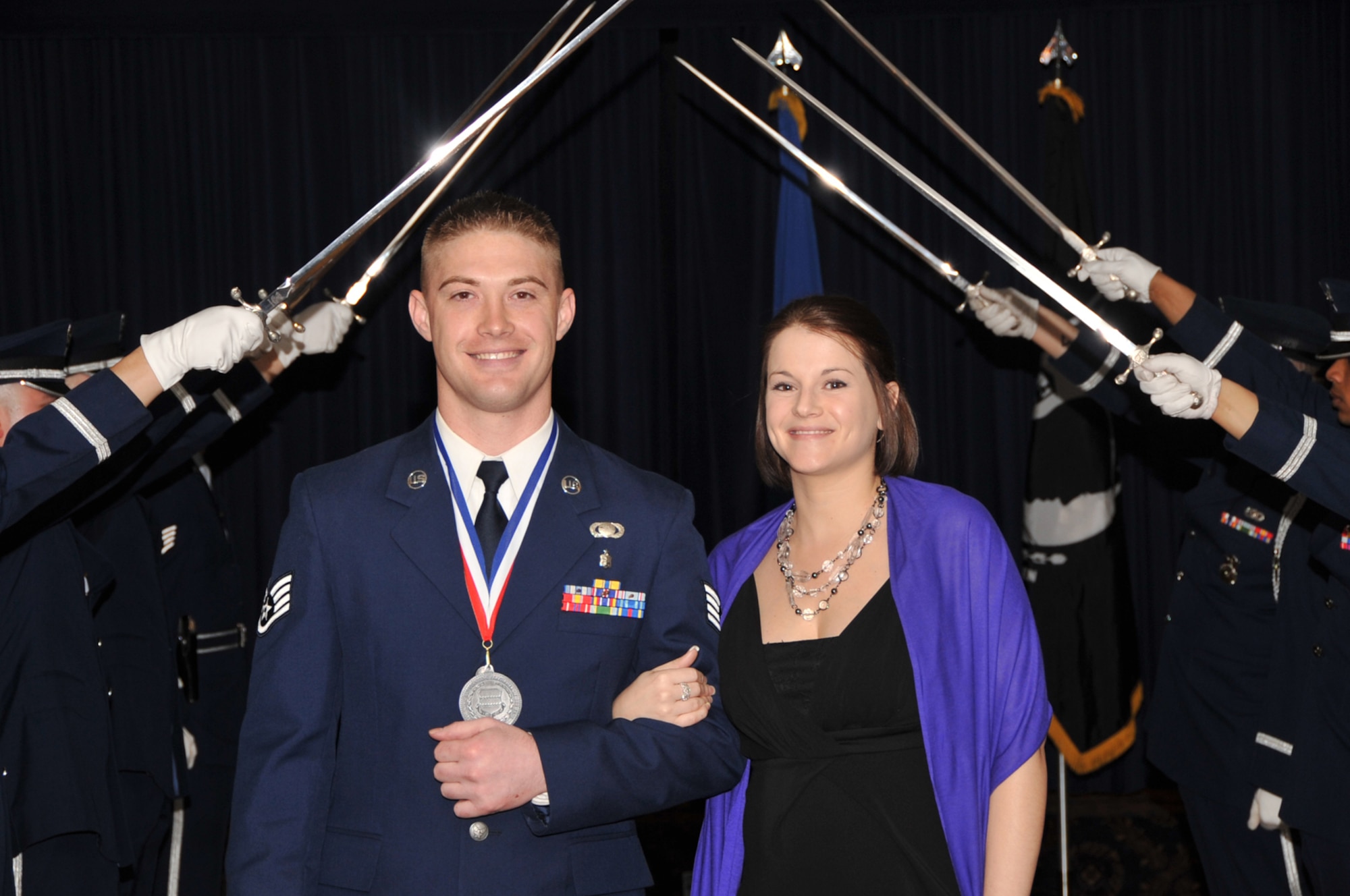 OFFUTT AIR FORCE BASE, Neb. - Staff Sgt. Alexander D. Larsen, with the 55th Contracting Squadron and his wife Vanessa, walk through a saber cordon as they were introduced at the 55th Wing Annual Awards Banquet at the Patriot Club here Feb. 26. U.S. Air Force photo by D.P. Heard