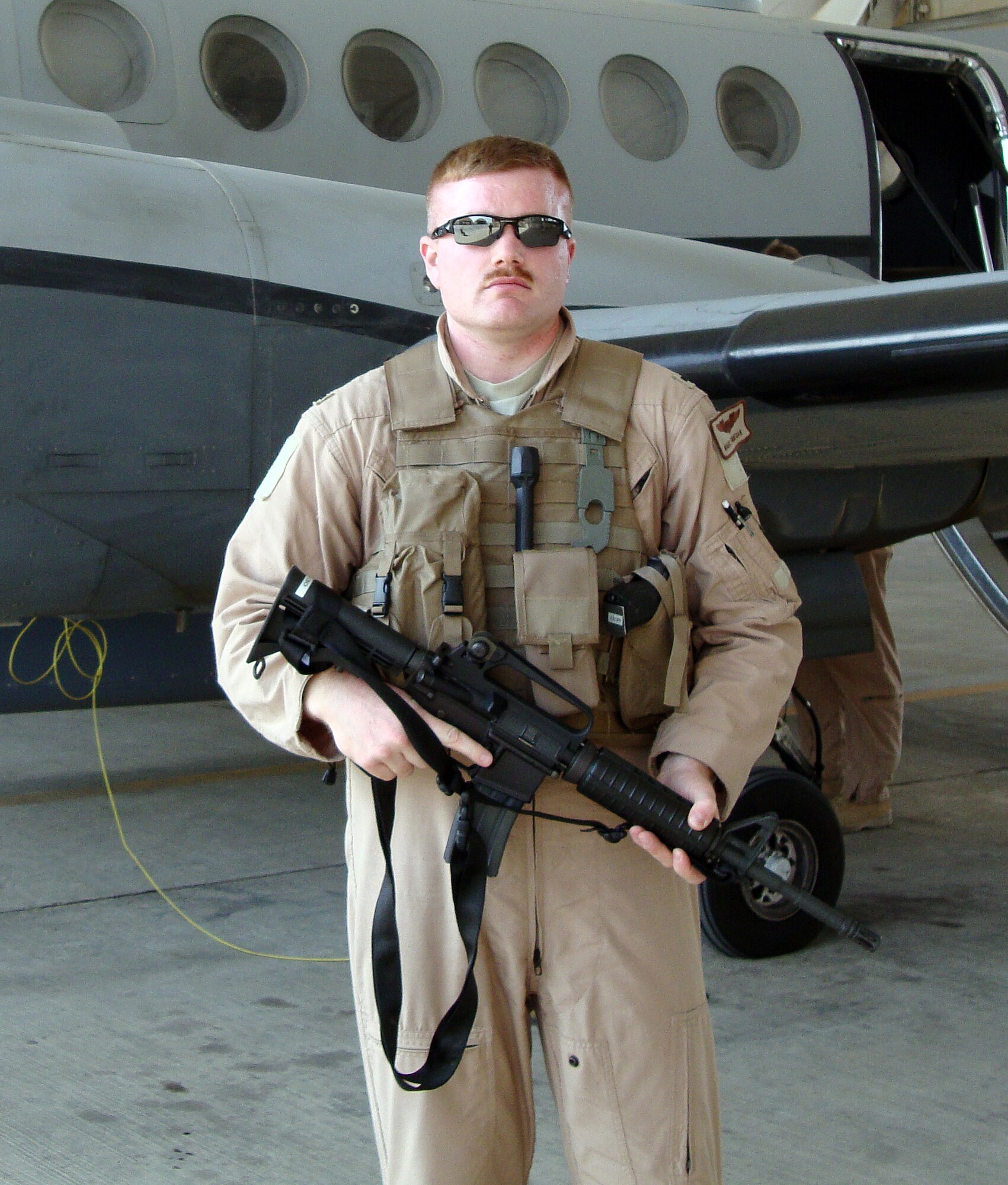 First Lieutenant Marc Finnegan stands in front of the MC-12W Liberty intelligence, reconnaissance and surveillance aircraft while in support of Operation Iraqi Freedom in Ballad, Iraq. (U.S. Air Force Photo)