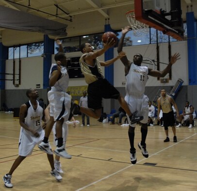 Senior Airman Rearco Truitt, 1st Special Operations Mission Support Group, lays up a basketball against James Matthews, Keesler Dragons, at the 2010 Southeastern Military Athletic Conference tournament at the Hurlburt Field Aderholt Fitness Center Feb. 28. The Air Commandos defeated the Dragons in the championship game 82-52. (U.S. Air Force photo by Airman 1st Class Joe McFadden)