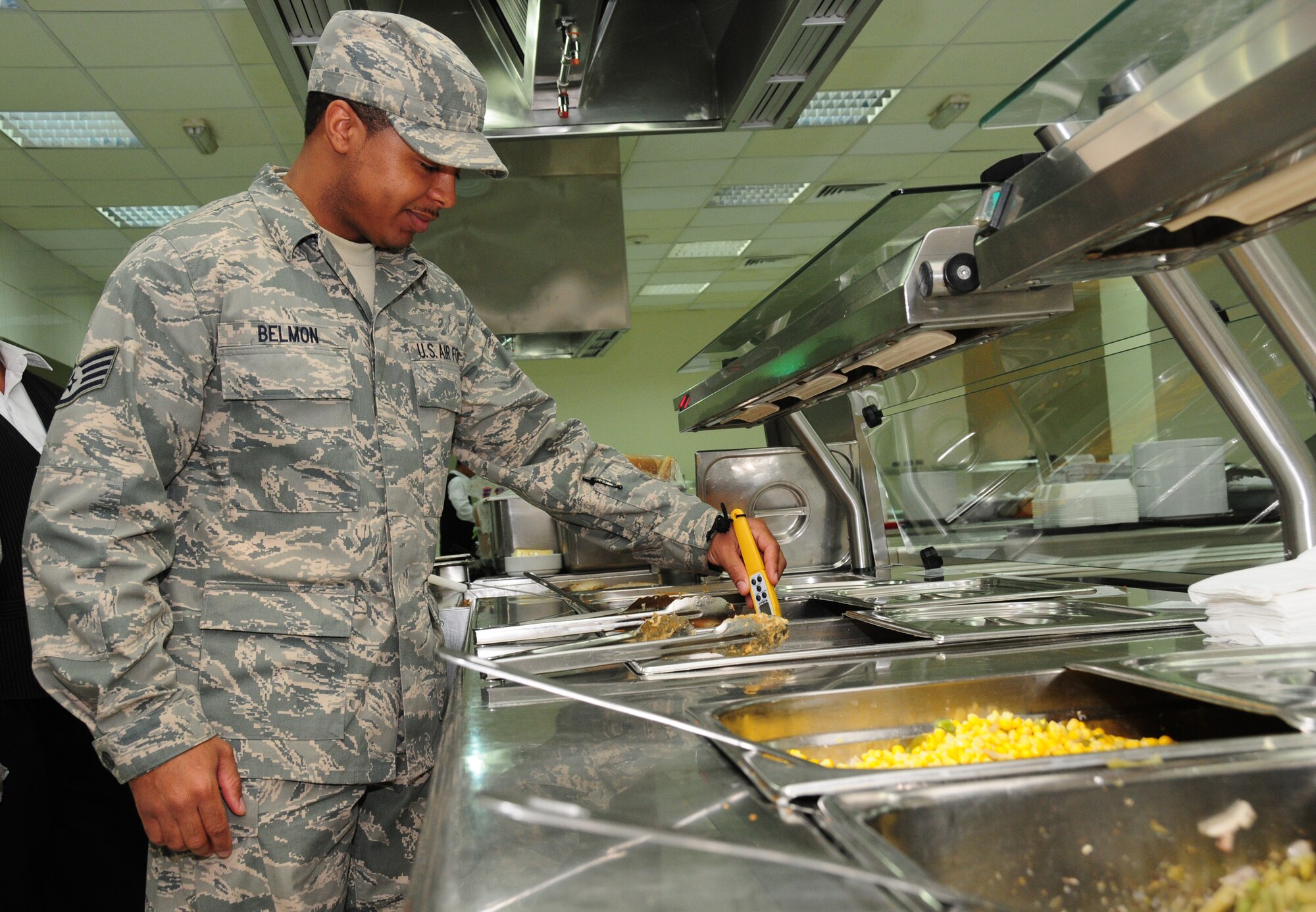 U.S. Air Force Staff Sgt. Morris Belmon, 386th Expeditionary Medical Group Public Health technician, checks the food temperature of a dish at the base dining facility March 3, 2010 at an air base in Southwest Asia. (U.S. Air Force photo by Staff Sgt. Lakisha Croley/Released)