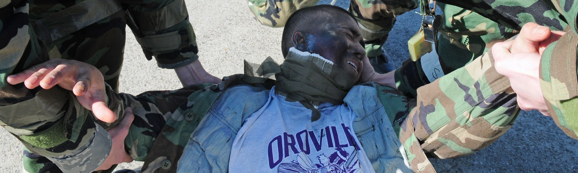 SPANGDAHLEM AIR BASE, Germany – Members of the 52nd Component Maintenance Squadron assist a moulage victim to his feet during an exercise scenario on the flightline March 2. A simulated electrical fire that caused injuries tested the self-aid and buddy care knowledge of first responders during Operation Saber Crown 10-05, a Phase II operational readiness exercise. (U.S. Air Force photo/Staff Sgt. Heather Norris)