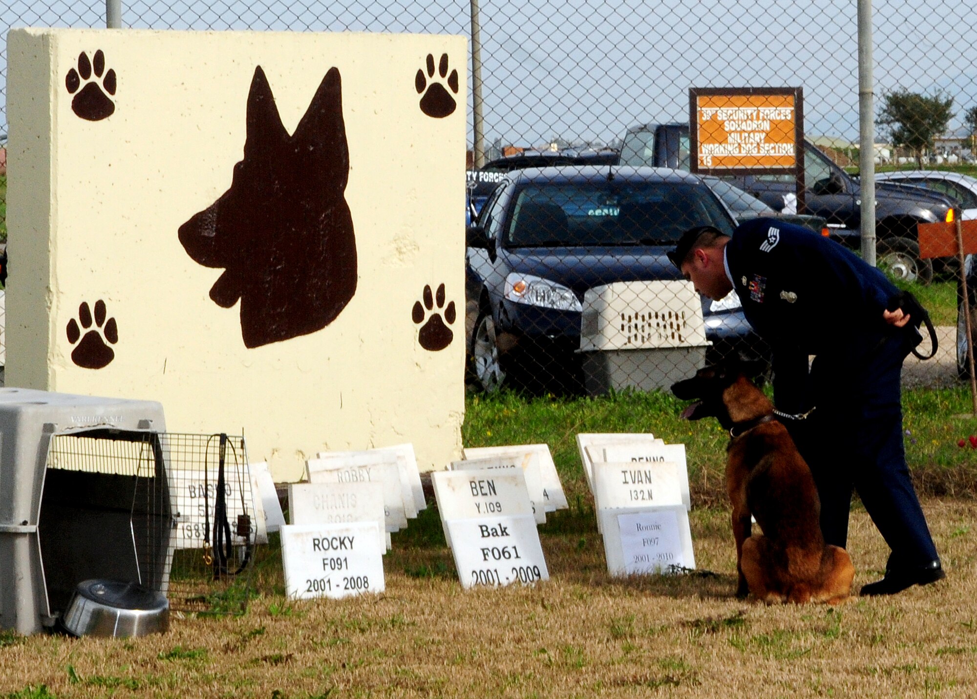 Staff Sgt. Frederick Thiessen, 39th Security Forces Squadron military working dog handler, lays flowers in front of a plaque dedicated to Ronnie, a fallen 39th SFS MWD, during his memorial ceremony Thursday, Feb. 25, 2010 at Incirlik Air Base, Turkey. During the ceremony, Ronnie received an Air Force Commendation Medal for his service, and speakers took turns sharing their experiences with the memorable MWD. (U.S. Air Force Photo/Senior Airman Alex Martinez)