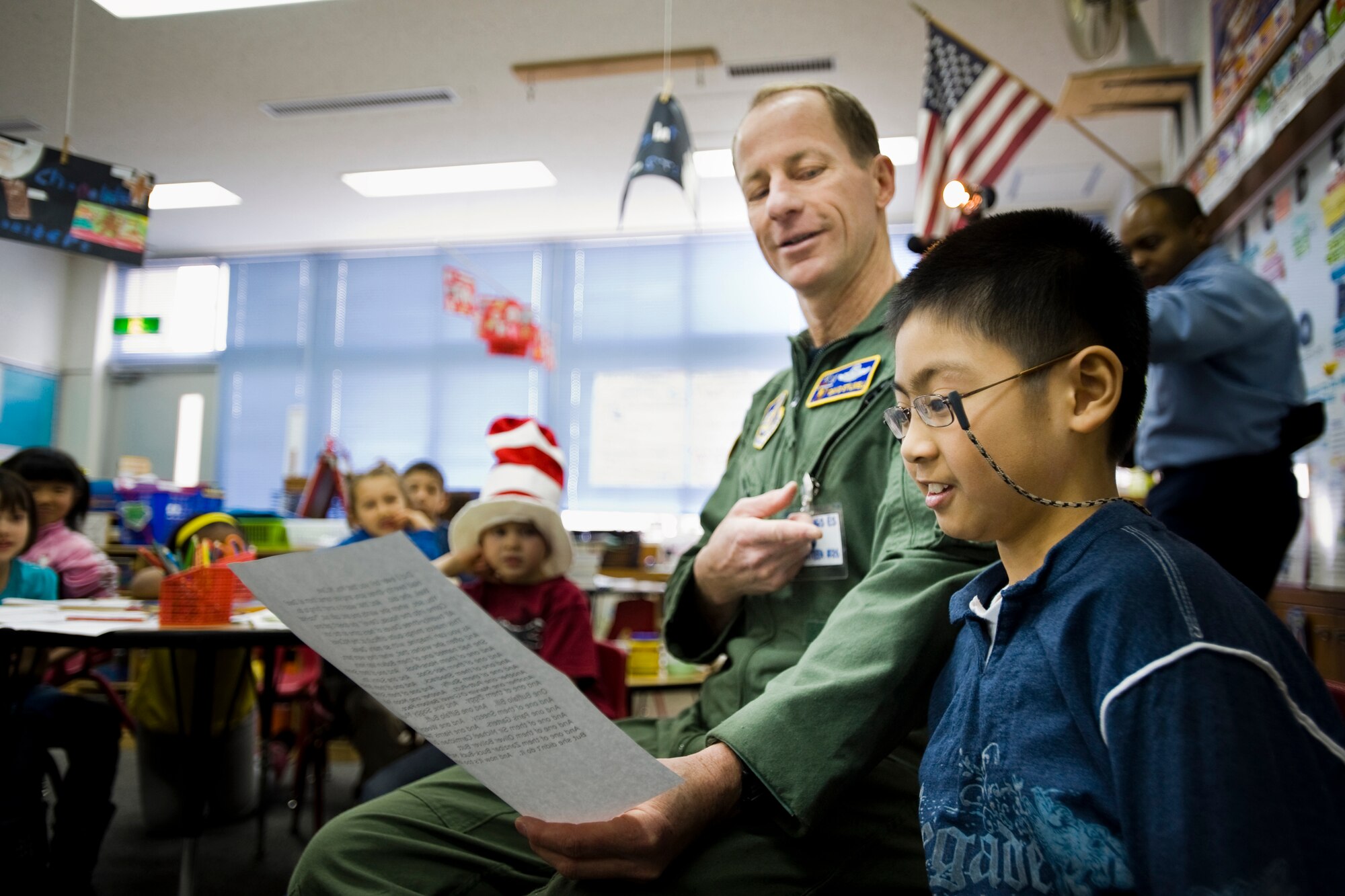 MISAWA AIR BASE, Japan -- Col. David Stilwell, 35th Fighter Wing commander, and David Deblois read Dr. Seuss' "Too Many Daves" to a class of 2nd and 3rd graders March 2 at Cummings Elementary School. Colonel Stilwell chose David to help him read the poem since they have the same first name. (U.S. Air Force photo/Senior Airman Jamal D. Sutter)
