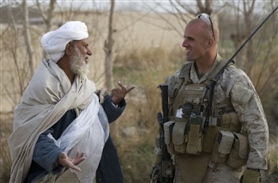 U.S. Marine Corps Capt. Scott A. Cuomo, commander of Fox Company, Second Battalion, Second Marine Regiment, speaks with an Afghan villager in Garmsir district, Helmand province, Afghanistan, on Feb. 14, 2010.  