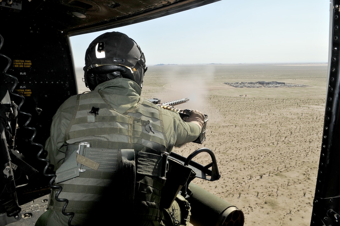 Sgt. Steven Houston, Marine Light Attack Helicopter Training Squadron 303 crew chief, engages targets with the .50-caliber machine gun mounted on his UH-1Y Venom helicopter while approaching the Barry M. Goldwater Range’s Yodaville urban target complex March 3, 2010. The squadron was conducting familiarization flights for new pilots and air crew for weapons training.