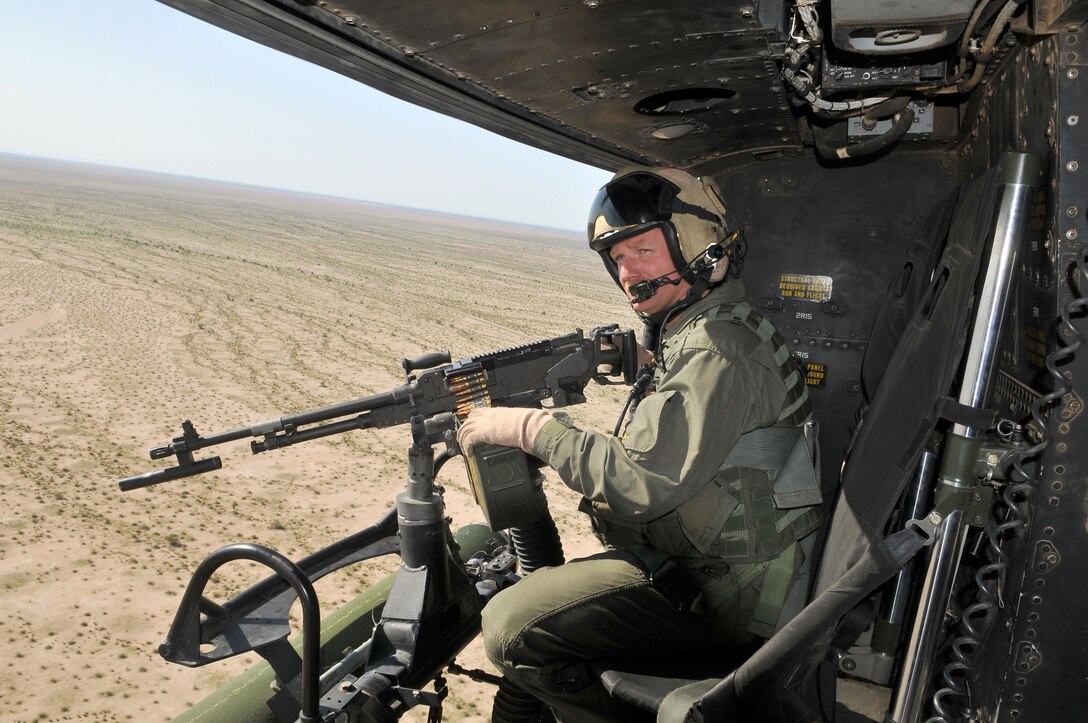 Gunnery Sgt. Aaron Jameson, Marine Light Attack Helicopter Training Squadron 303 crew chief, searches for targets to engage with the M-240 machine gun mounted on his UH-1Y Venom helicopter while approaching the Barry M. Goldwater Range’s Yodaville urban target complex March 3, 2010. The squadron was conducting familiarization flights for new pilots and air crew for weapons training.