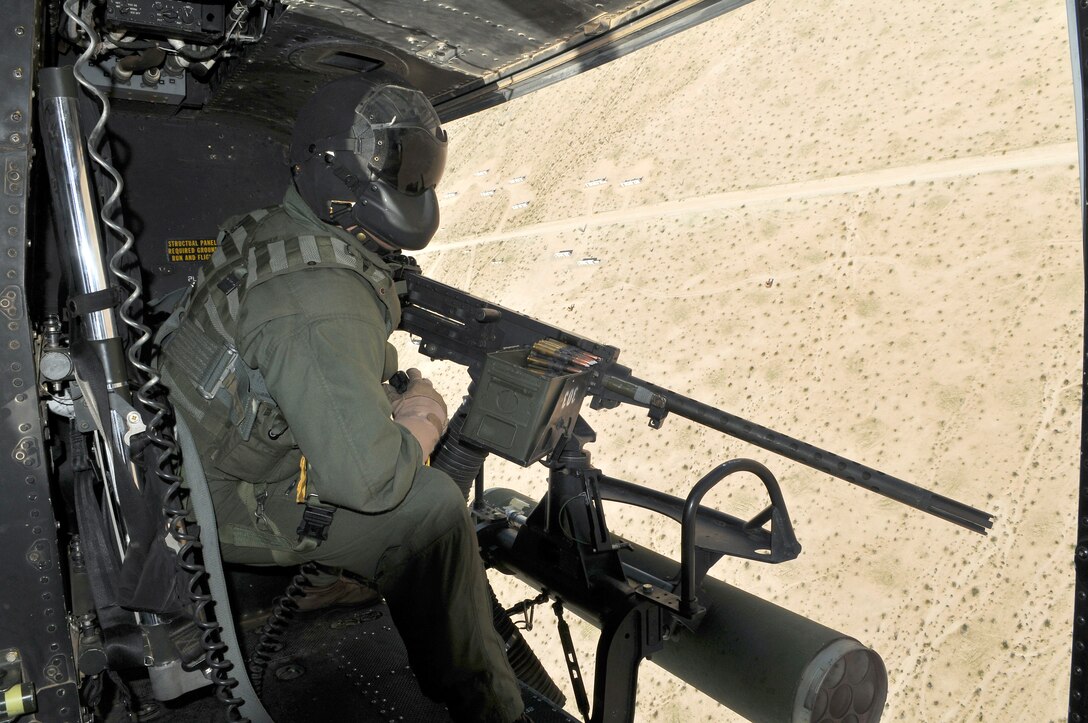 Sgt. Steven Houston, Marine Light Attack Helicopter Training Squadron 303 crew chief, searches for targets to engage with the .50-caliber machine gun mounted on his UH-1Y Venom helicopter while approaching the Barry M. Goldwater Range’s Yodaville urban target complex March 3, 2010. The squadron was conducting familiarization flights for new pilots and air crew for weapons training.