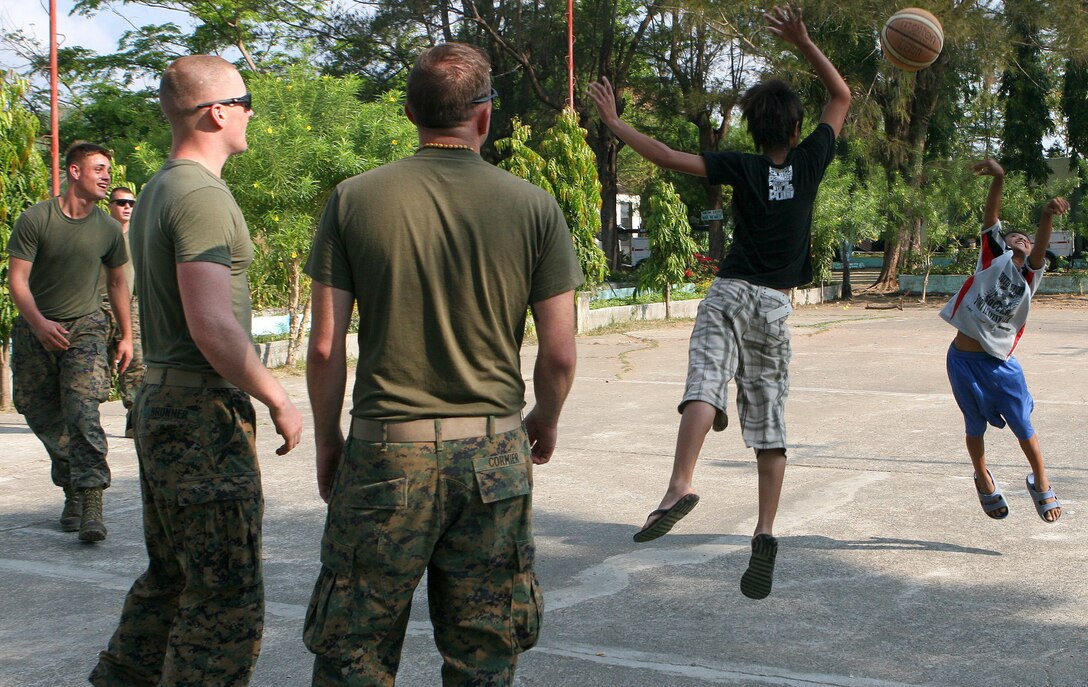 Marines and sailors with Combat Logistics Battalion 31 (CLB-31), 31st Marine Expeditionary Unit (MEU), join local children in a friendly game of basketball, March 4. CLB-31 is currently renovating Marnay Primary School in support of Balikatan 2010 (BK ’10). Servicemembers from the Armed Forces of the Philippines (AFP) and the 31st MEU are training together during BK ’10 to hone their civil-military interoperability skills to ensure more responsive, efficient and effective relief efforts.