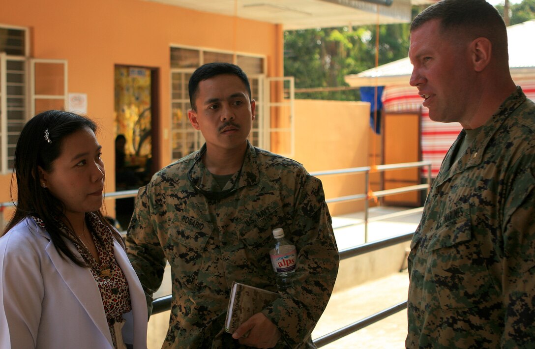 Maj. Peter Forsythe (right), executive officer for Combat Logistics Battalion 31 (CLB-31), 31st Marine Expeditionary Unit (MEU), and Chief Petty Officer Joshua Rosario, a hospital corpsman with CLB-31, discuss medical capabilities of the local hospital with Lynn Bueno, a resident physician at Corpuz Clinic and Hospital, during a facility tour, March 4. Marines and sailors with CLB-31 are currently renovating Marnay Primary School in support of Balikatan 2010 (BK ’10). Servicemembers from the Armed Forces of the Philippines (AFP) and the 31st MEU are training together during BK ’10 to hone their civil-military interoperability skills to ensure more responsive, efficient and effective relief efforts.