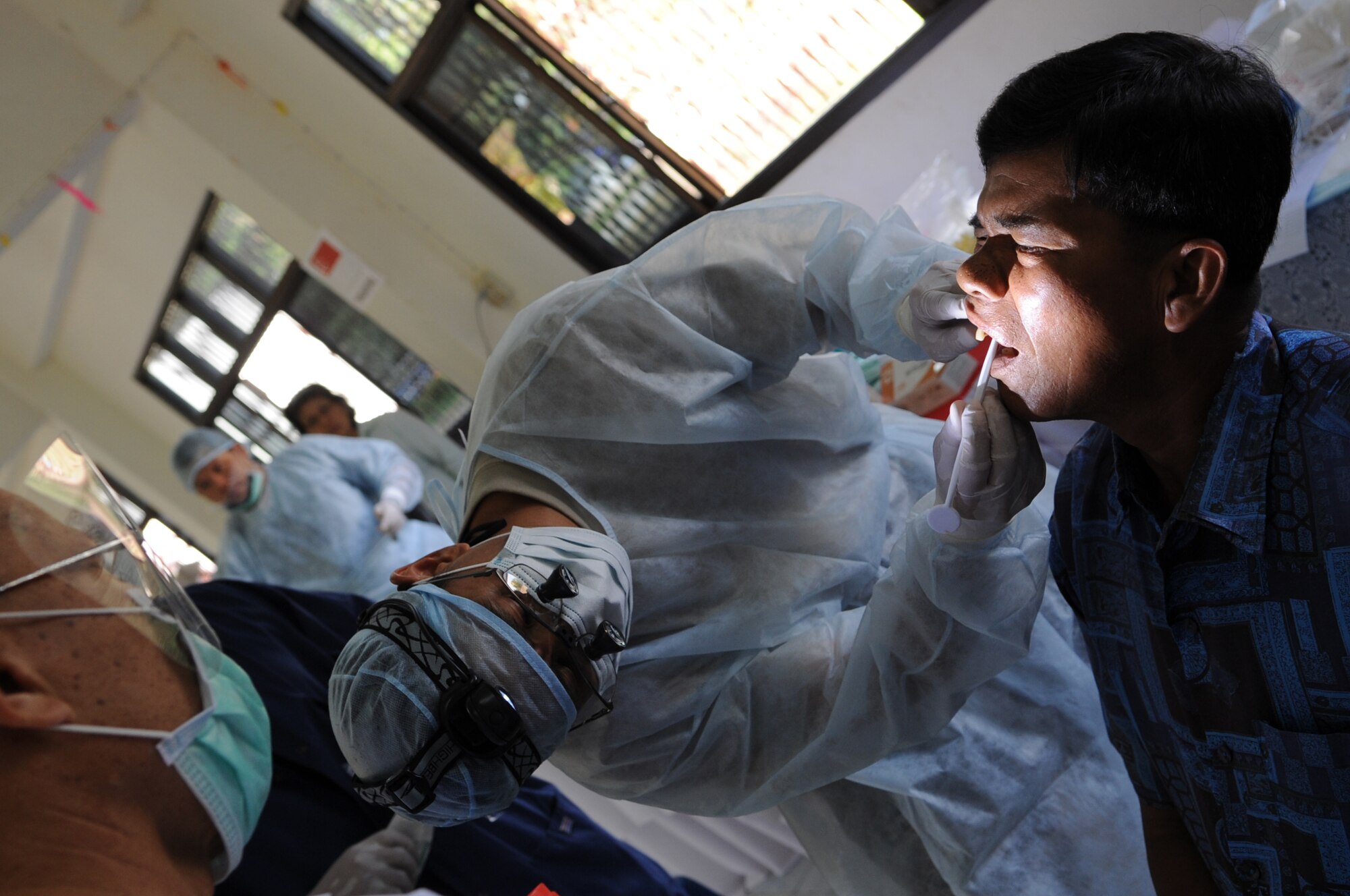 A local Thai resident has his teeth examined at Bau Nong Sroung School in Thailand during a Cope Tiger 2010 community relations event March 4.  Airmen from the U.S., Royal Thai and Republic of Singapore air forces teamed up to provide medical, dental and optometry care at the school to local residents as part of Cope Tiger 2010.  Money, school supplies, toys and games were also donated by all three air forces for the children at the school.  (U.S. Air Force photo/Tech Sgt. Cohen A. Young)