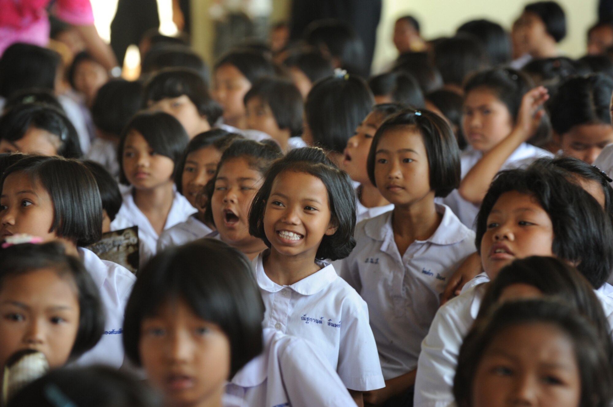 Students of the Bau Nong Sroung School in Thailand enjoy some local entertainment during a Cope Tiger 2010 community relations event March 4.  Airmen from the U.S., Royal Thai and Republic of Singapore air forces teamed up to provide medical, dental and optometry care at the school to local residents as part of Cope Tiger 2010.  Money, school supplies, toys and games were also donated by all three air forces for the children at the school.  (U.S. Air Force photo/Tech Sgt. Cohen A. Young)
